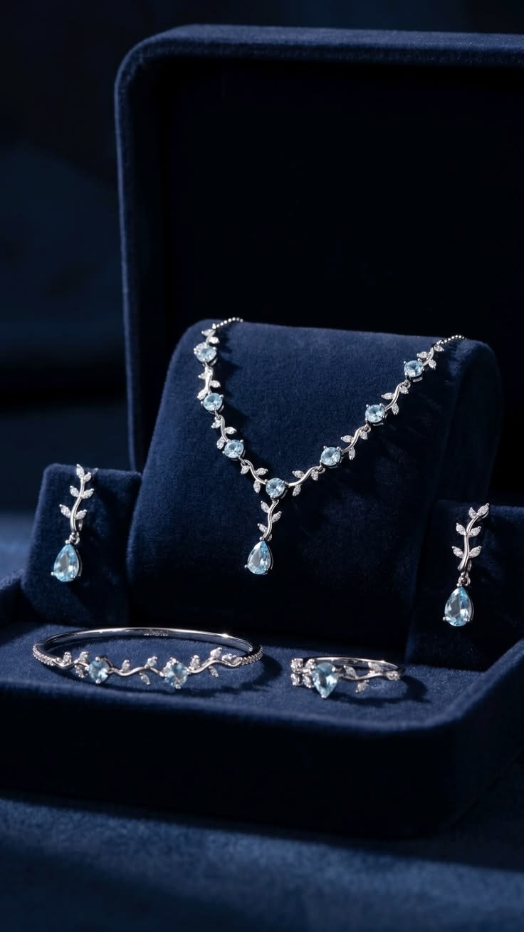 Elegant silver necklace and jewelry set displayed on navy velvet