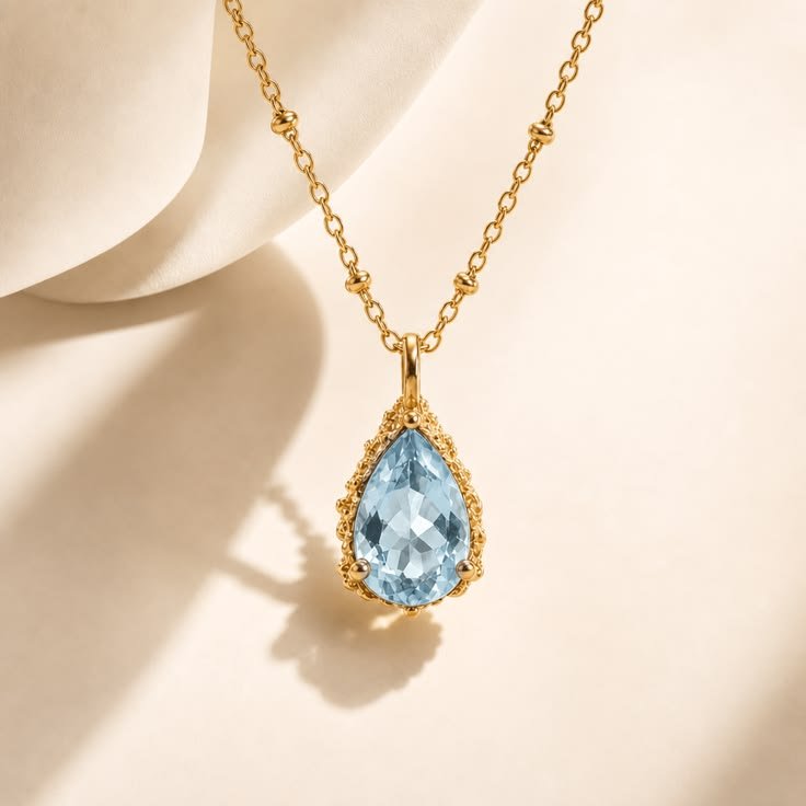 Aurelia gold necklace with blue teardrop pendant
