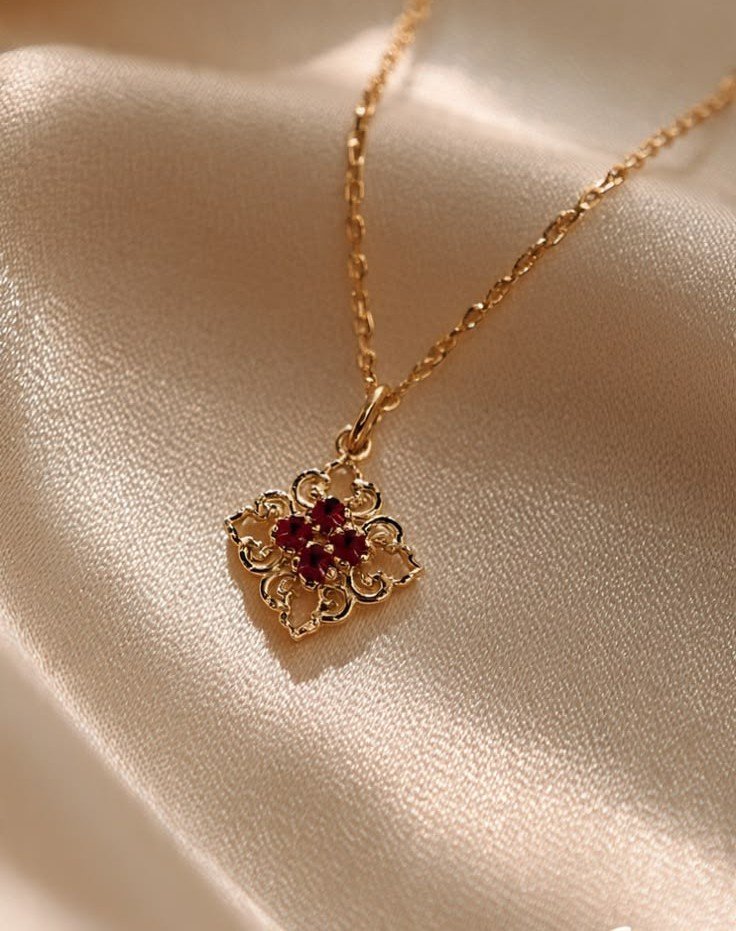 Elara gold necklace with red floral pendant